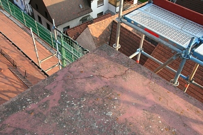 Aber auch tiefe Risse durchzogen diese Betonplatten.
Durch diese Risse konnte Feuchtigkeit eindringen und bei Frost weitere Betonteile absprengen.
Auch die tragende Betondecke darunter wäre durch diese Feuchtigkeit über kurz oder lang beschädigt worden.